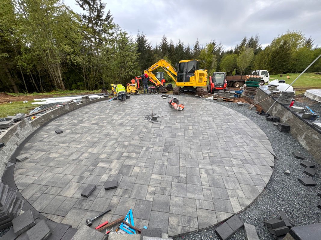 Patio Pavers Being Installed for a Large Fire Pit by Ivans Landscape Construction