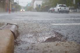 Rainwater flowing into street drain during storm in Snohomish Washington