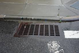 Rainwater flowing into street drain during storm in Snohomish Washington