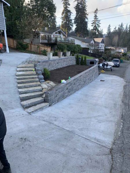 Newly constructed retaining wall and steps in suburban neighborhood.