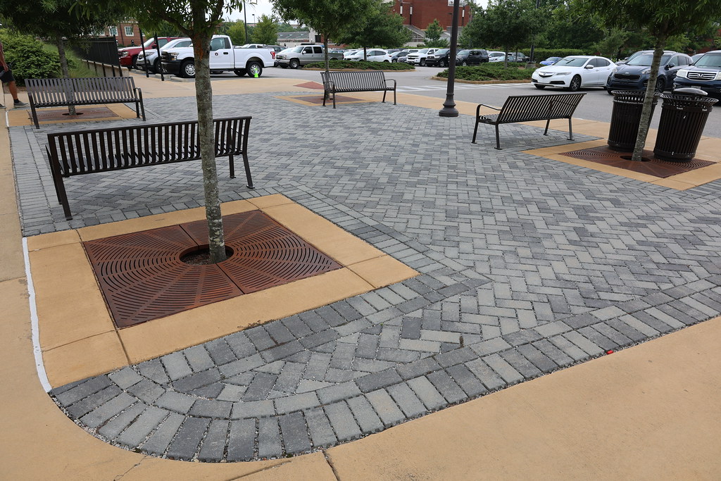 Outdoor seating area with benches and paved walkway