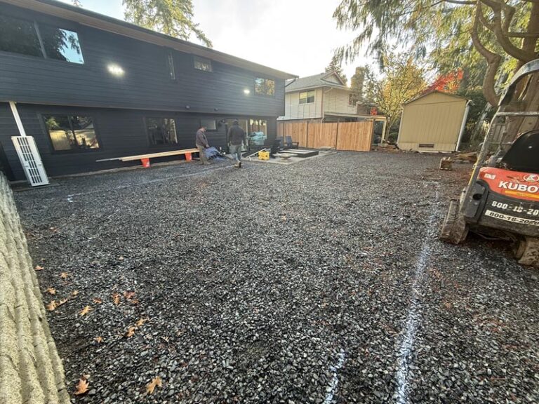 full backyard having hardscape patio prepared while covering it with gravel stones with ivans landscape and construction