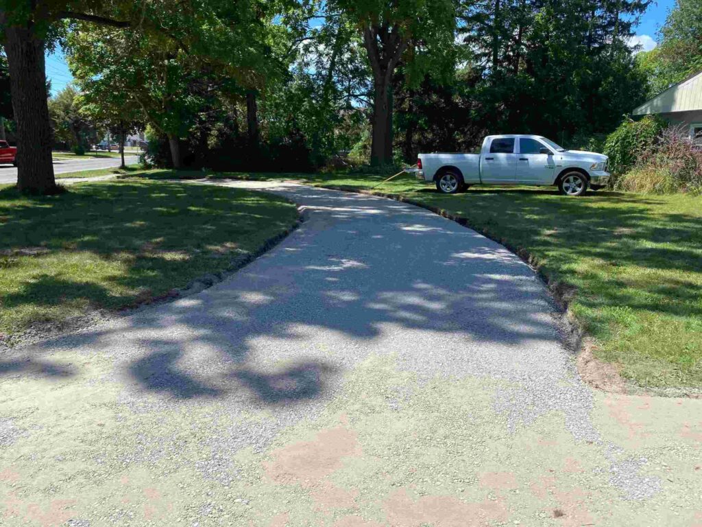 Newly paved driveway near white pickup truck