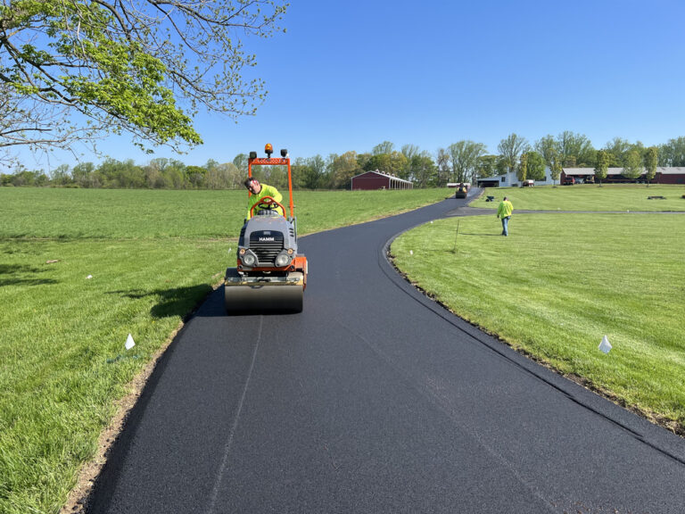 Workers paving new asphalt road in countryside