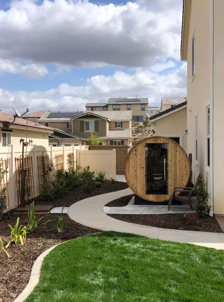 Backyard with wooden sauna and green lawn