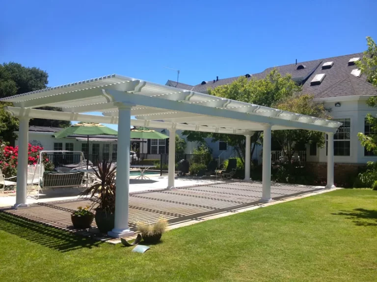 Backyard patio pergola beside house and pool