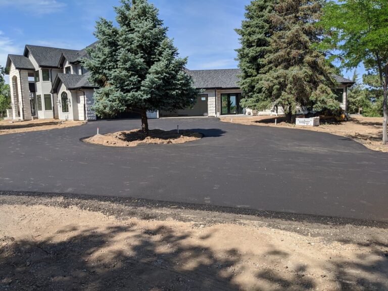 Freshly paved driveway in front of modern house